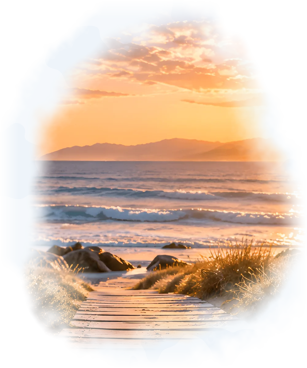 A wooden path through the dunes towards a sunrise over the sea